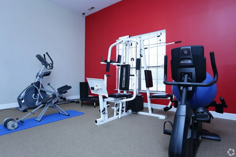 Fitness room with a weight machine, elliptical and bike