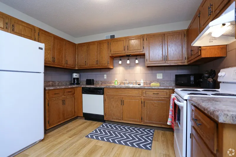 Fully equipped kitchen with white appliances