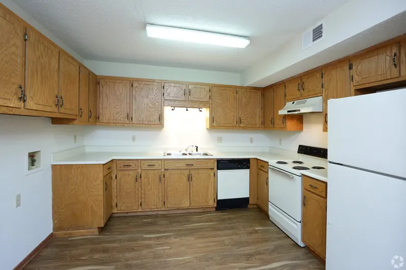 Kitchen with wood cabinets and white appliances